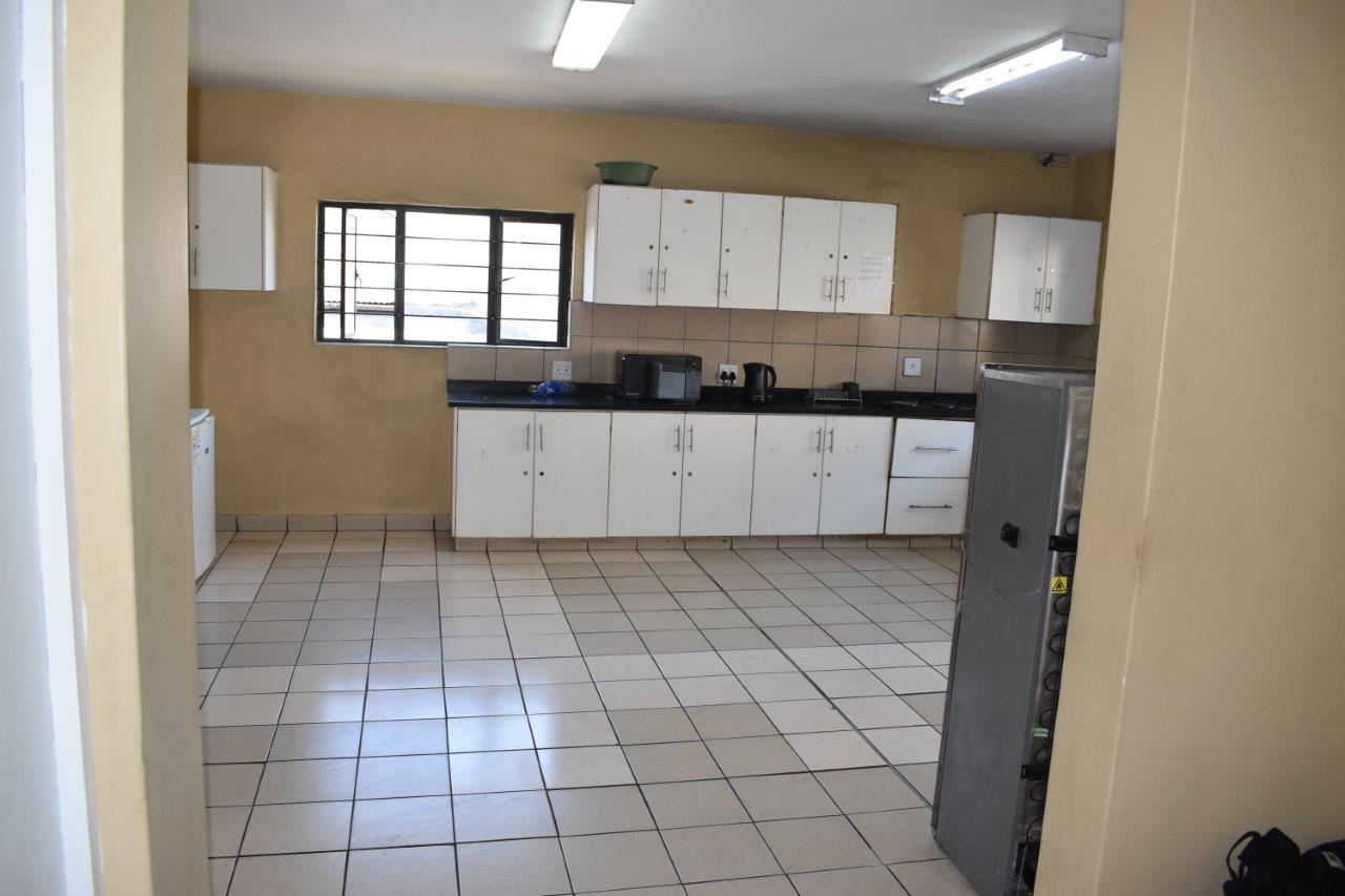 Communal kitchen with stove, fridge, and counter space