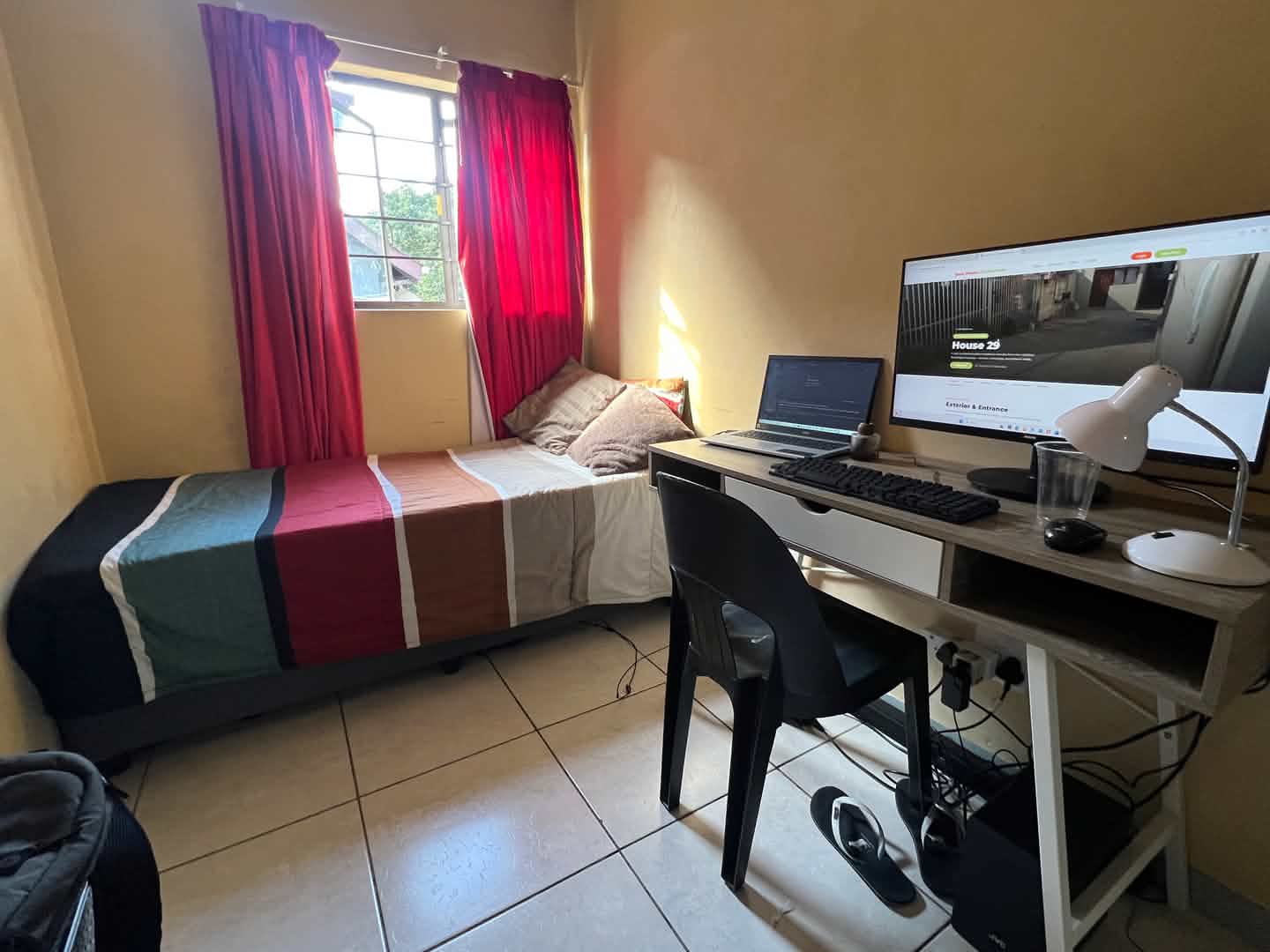 Furnished single bedroom with study desk and wardrobe